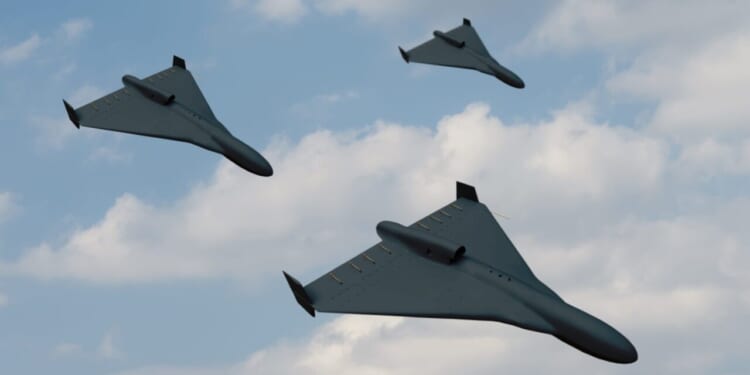 Group attack of black drones of modern suicide bombers flying against the background of blue sky and clouds.