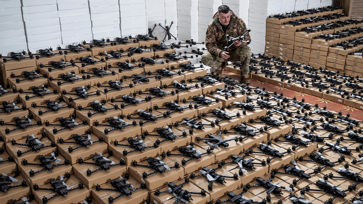 A Ukrainian serviceman inspects a first person view (FPV) drone. 