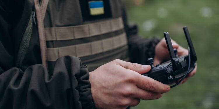 Closeup of Ukrainian military man controlling a drone.