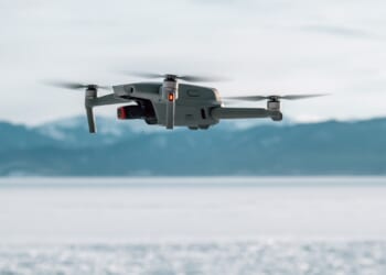 A drone against a snowy mountain backdrop.