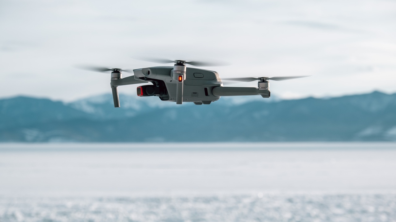 A drone against a snowy mountain backdrop.