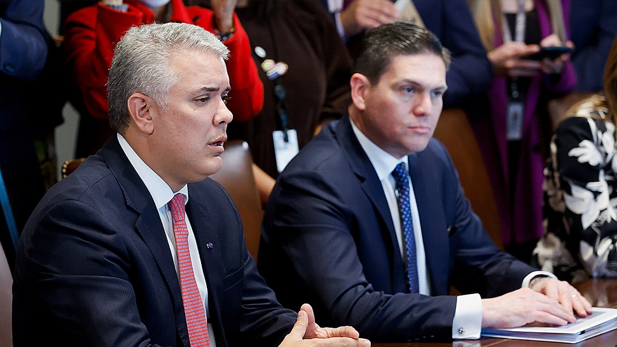 Colombia's President Iván Duque and Colombia's Ambassador to the U.S. Juan Carlos Pinzón attend a meeting with U.S. President Joe Biden in the Cabinet Room at the White House in Washington, March 10, 2022.