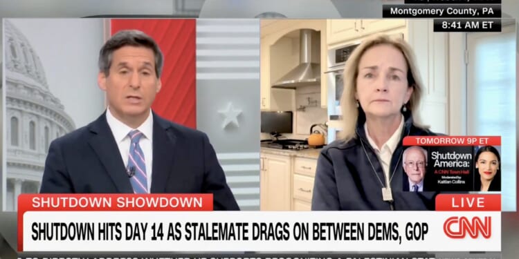 CNN hosts discuss the ongoing government shutdown on a live broadcast, highlighting the 14th day of the stalemate between Democrats and Republicans.