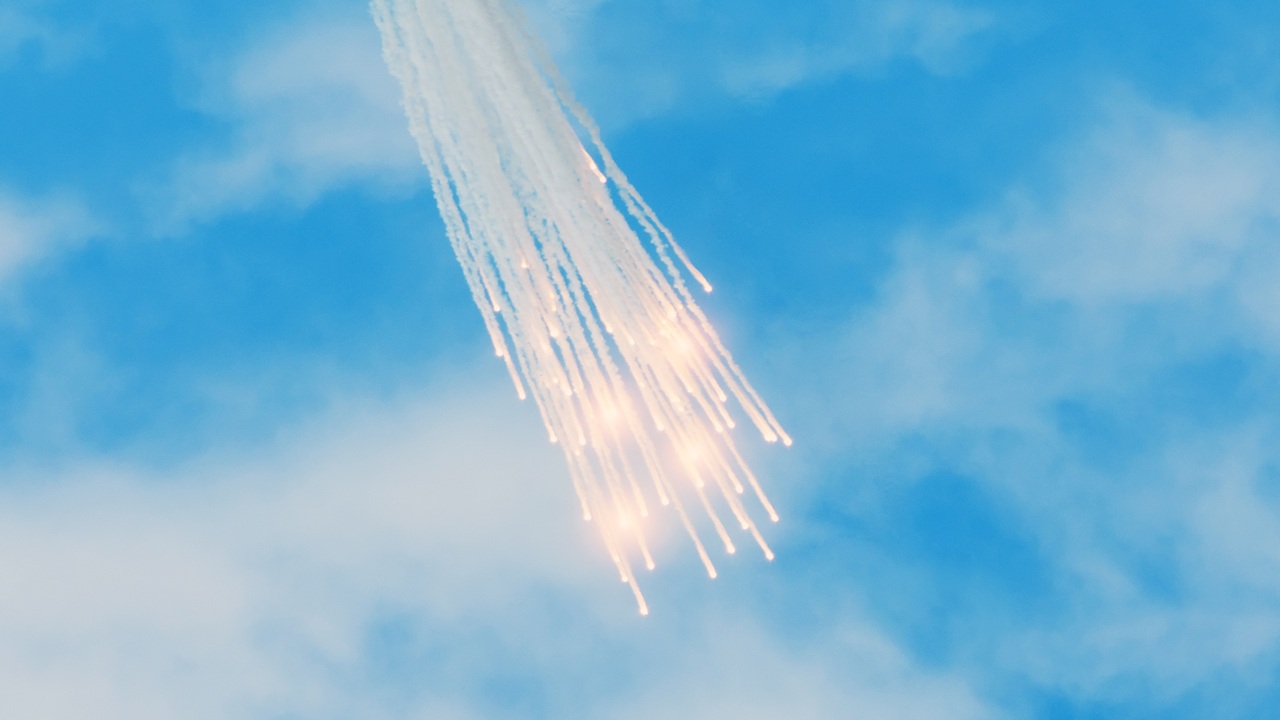 A group of white phosphorus flares falling from the sky.