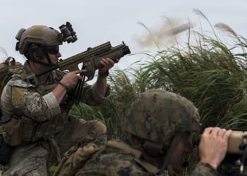 A soldier firing a grenade launcher.