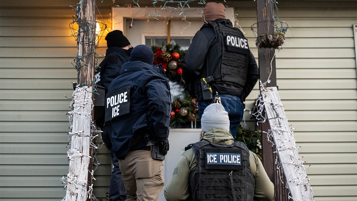 ICE agents knocking on the front door of a residence in Chicago