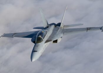 Top view of a FA-18F Super Hornet over clouds.