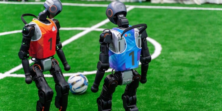 Chongqing, China - Sep, 5th 2025: humanroid robots play foot game during Smart China Expo.The robot is from chinese leading robot company Unitree.
