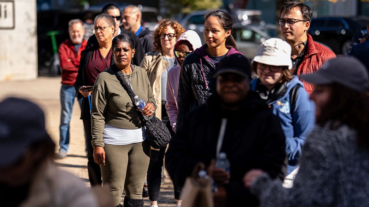 People wait in line at Chef Jose Andres' World Kitchen as shutdown continues.
