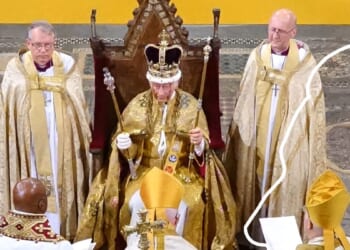 Ceremonial event featuring a crowned figure in ornate robes, flanked by clergy in golden vestments, during a religious service.