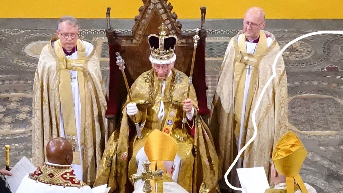 Ceremonial event featuring a crowned figure in ornate robes, flanked by clergy in golden vestments, during a religious service.