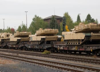 A group of tanks on a train.