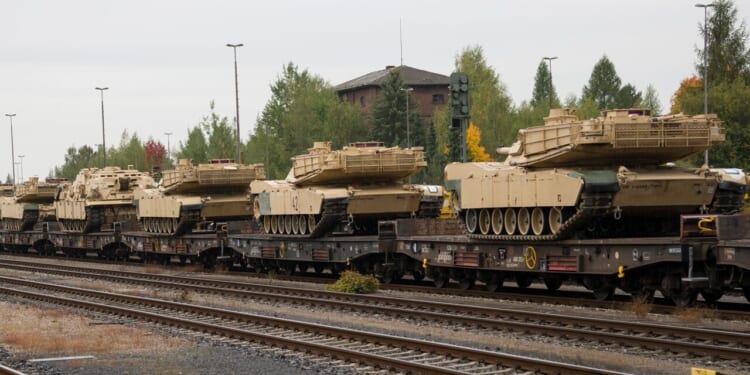 A group of tanks on a train.