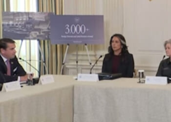 Meeting at the White House discussing foreign investment, featuring three officials and a presentation highlighting over 3,000 new jobs created.