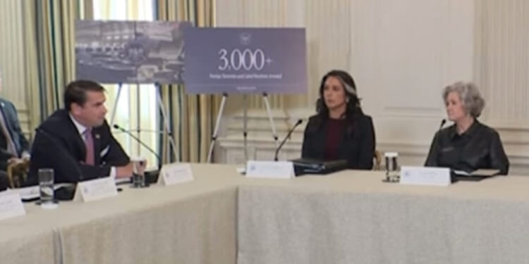 Meeting at the White House discussing foreign investment, featuring three officials and a presentation highlighting over 3,000 new jobs created.