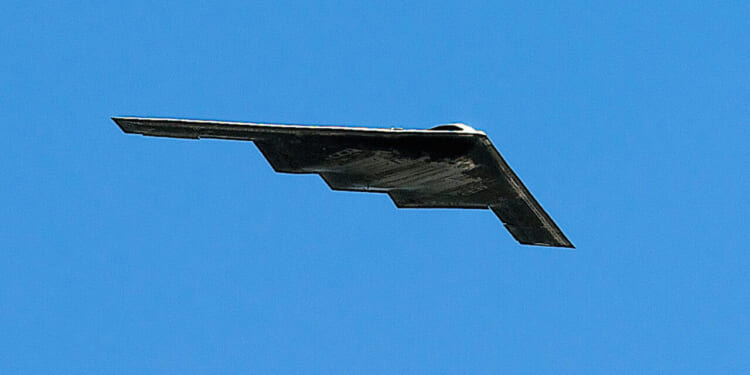 A Northrop Grumman B-2 Spirit Stealth bomber flies overhead at the dedication of the Air Force Memorial in Arlington Virginia.