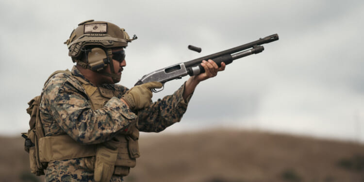 U.S. Marine Corps Lance Cpl. Albert Aguilera, a student with the Small Unmanned Aircraft System Integration Course, 1st Marine Division Schools, fires a Benelli M4 semi-automatic shotgun during a SUAS integration field exercise on Marine Corps Base Camp Pendleton, California, Jan. 30, 2024.