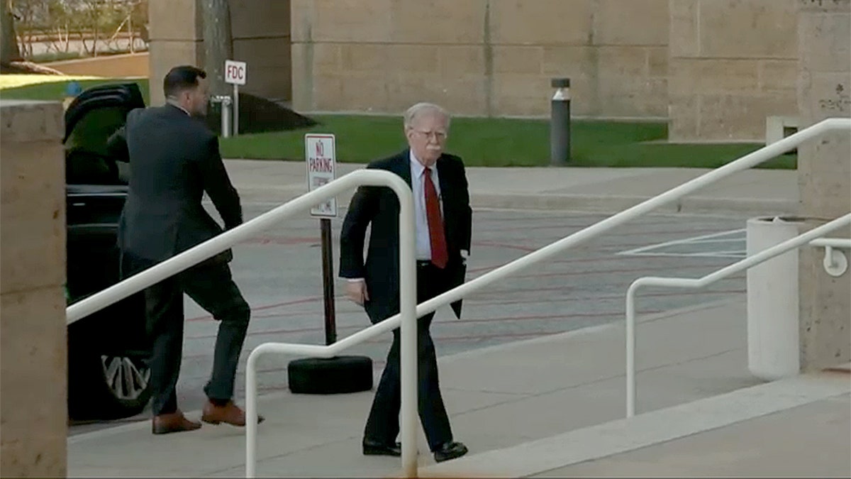 John Bolton walks into federal courthouse to surrender to authorities