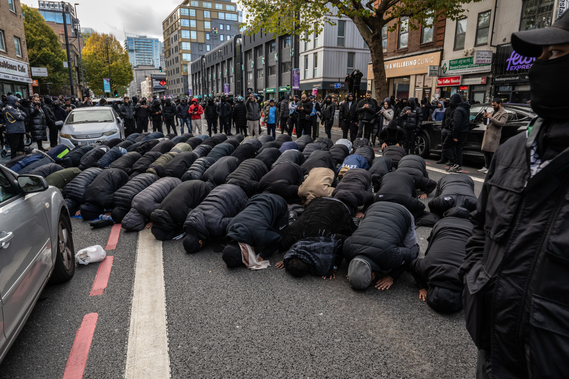LONDON, ENGLAND - OCTOBER 25: Members of the Bangladeshi community stop for prayers outside the East London Mosque on October 25, 2025 in London, England. (Photo by Guy Smallman/Getty Images)