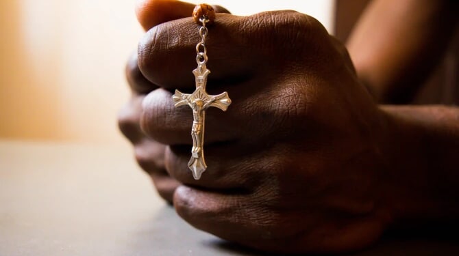 Hands praying rosary