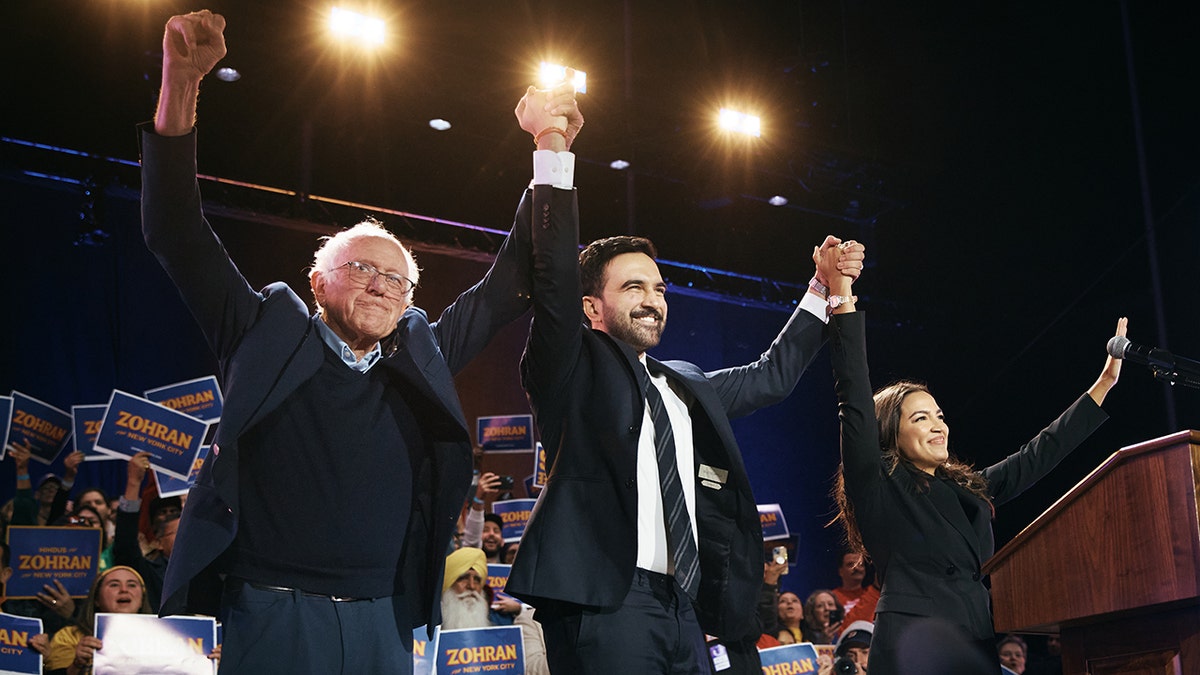 Sen. Bernie Sanders and Rep. Alexandria Ocasio-Cortez hold hands with New York City mayoral candidate Zohran Mamdani