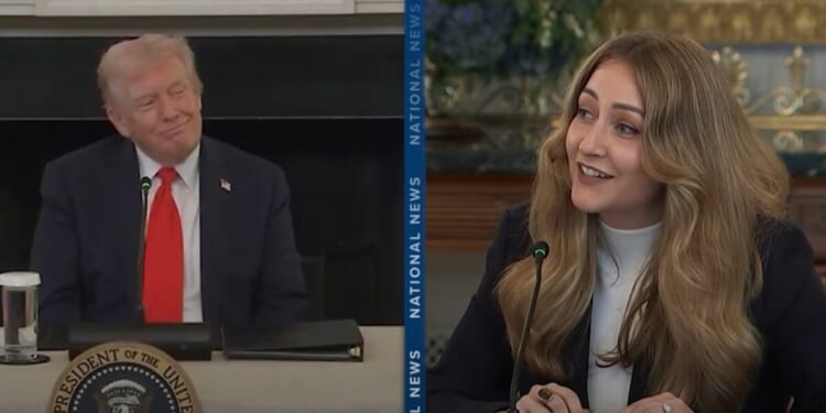 Donald Trump and a woman speaking during a discussion at a presidential event, both engaged and smiling, emphasizing a collaborative atmosphere.