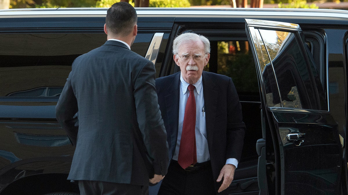 John Bolton exits vehicle as he arrives at court
