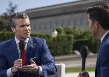 Secretary of Defense Pete Hegseth giving an interview outside the Pentagon.