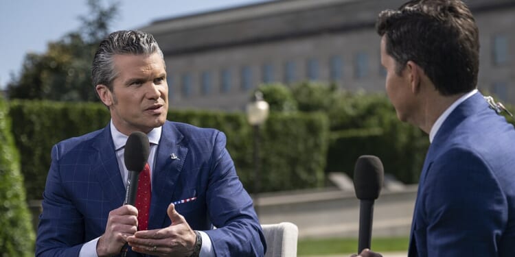 Secretary of Defense Pete Hegseth giving an interview outside the Pentagon.