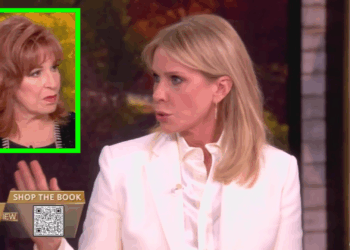 Two women speaking on a talk show, one in a white blazer and the other with red hair, discussing a topic with animated expressions.