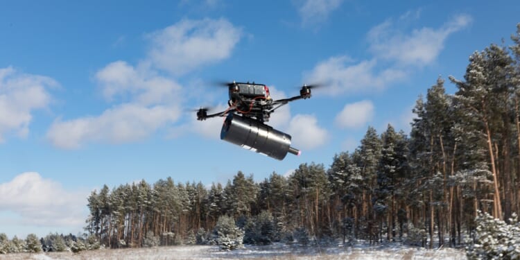 A fiber optic drone emerging from a forest.