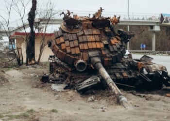 A destroyed Russian tank sits in a Ukrainian city.