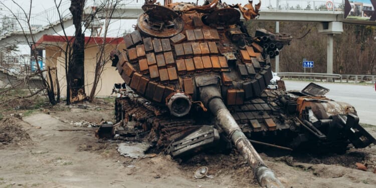 A destroyed Russian tank sits in a Ukrainian city.