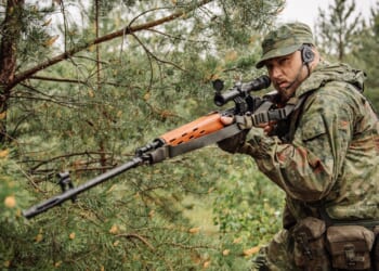 A soldier carrying a Dragunov sniper rifle.