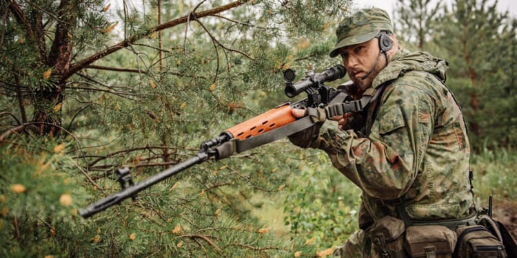A soldier carrying a Dragunov sniper rifle.
