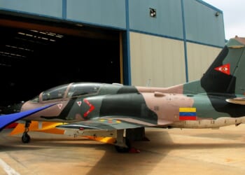 A Venezuelan fighter jet outside a hangar.