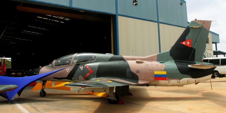 A Venezuelan fighter jet outside a hangar.