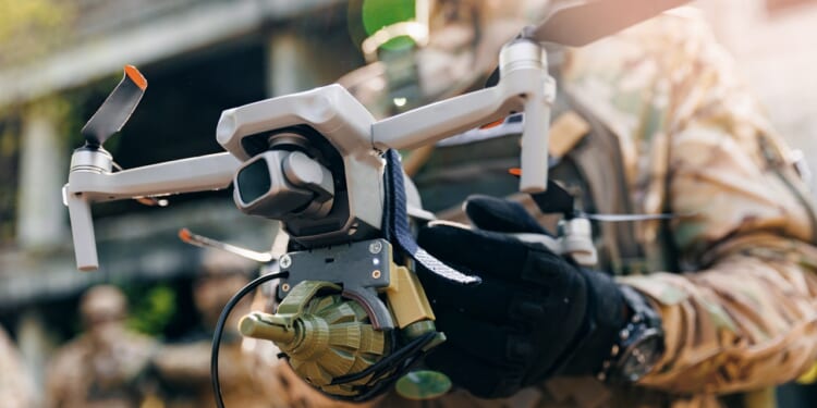 A soldier holding a drone.
