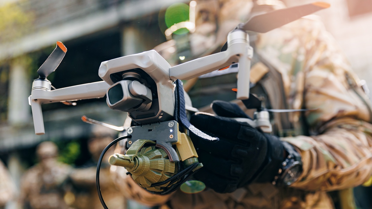 A soldier holding a drone.