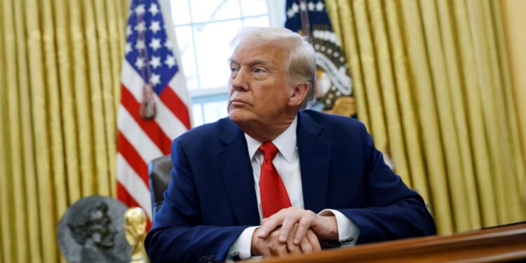 President Donald Trump sits in the Oval Office, White House.