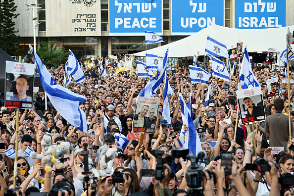 People gather to watch the hostage release live stream at Hostages Square
