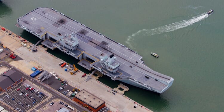 The HMS Prince of Wales at a dock.