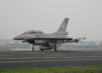 An F-16 fighter on a highway.