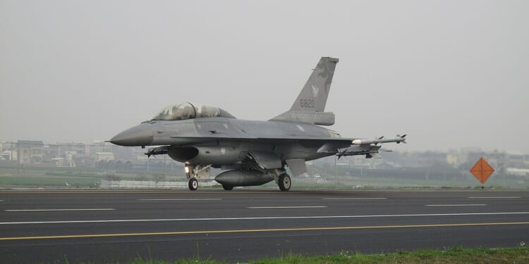 An F-16 fighter on a highway.