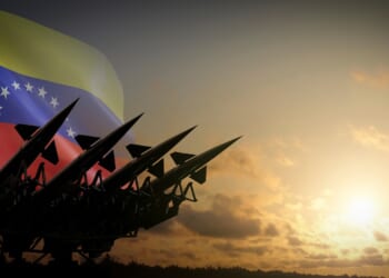 A battery of missiles against a Venezuelan flag.