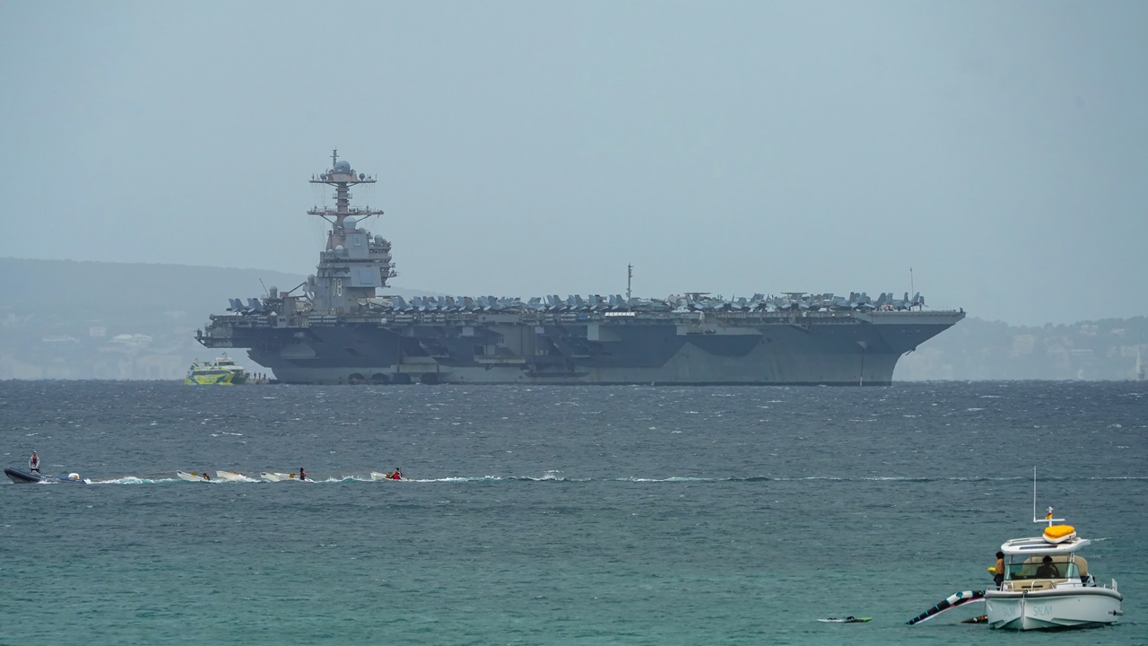 The USS Gerald R. Ford aircraft carrier, seen in the distance.