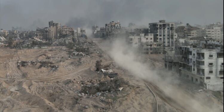 Dust rises from ruins in Gaza.