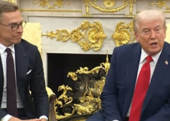 Donald Trump and a European leader engage in discussion during an official meeting in an ornate room, showcasing diplomatic relations and international cooperation.