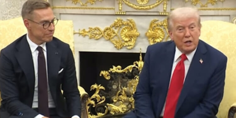 Donald Trump and a European leader engage in discussion during an official meeting in an ornate room, showcasing diplomatic relations and international cooperation.
