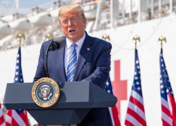 Trump giving a speech on a US Navy ship.